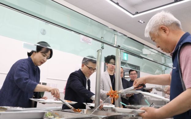 직원과 함께 배식받는 사진